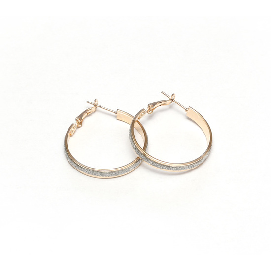 Gold tone hoop earrings with silver glitter