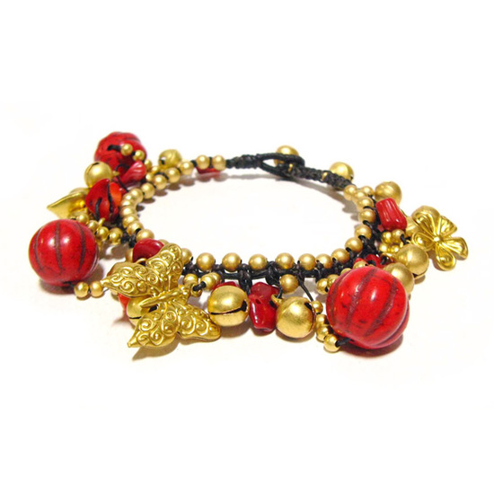 Handmade gold-tone beads, butterfly charm, bells and red coral stones woven with waxed cord anklet