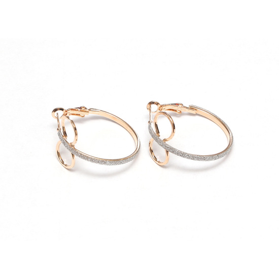 Gold tone double hoop earrings with silver glitter...